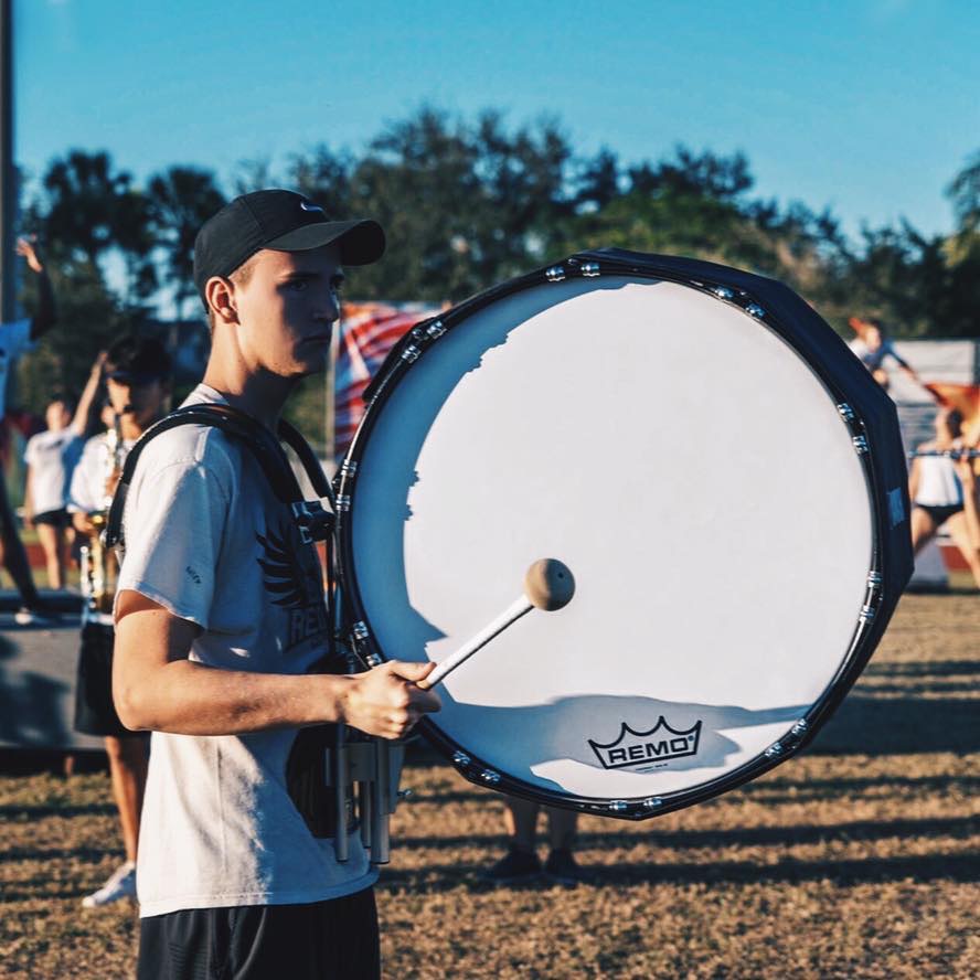 Nicholas Hernandez and set in his drill for the marching band show holding his drum.