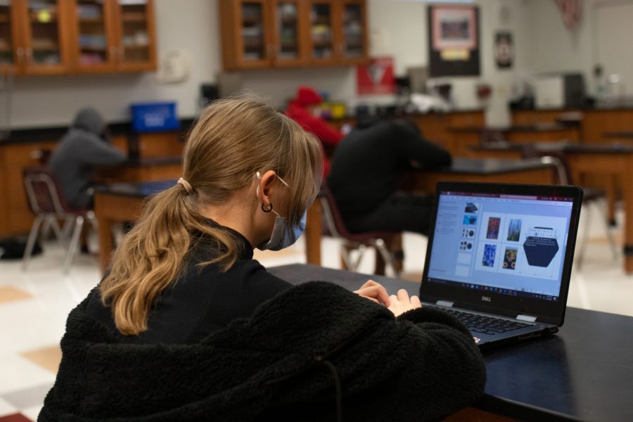 student sitting in class six-feet-apart