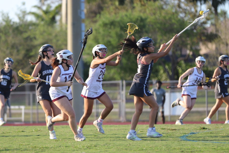 MSD varsity lacrosse players pressure NSU University School player in their pursuit to take back the ball. They attempt to get a turnover in order to score once more.