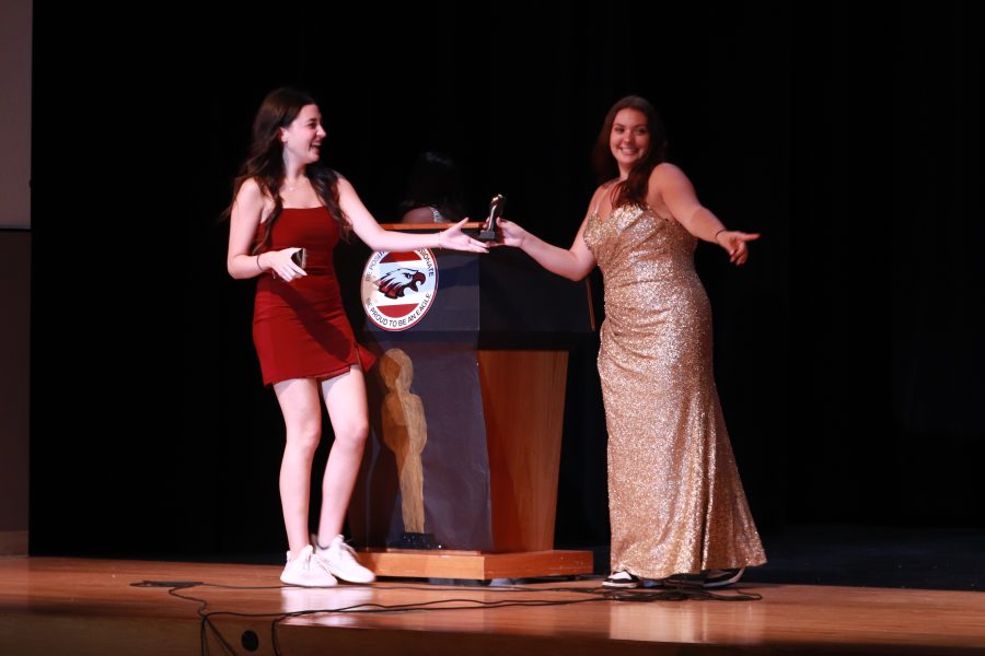 Senior Adriana Pena receives her trophy for the award, "Broadway Bound", from Senior Faith Weiss. Weiss acted as the traditional trophy distributor as seen on the Oscars.