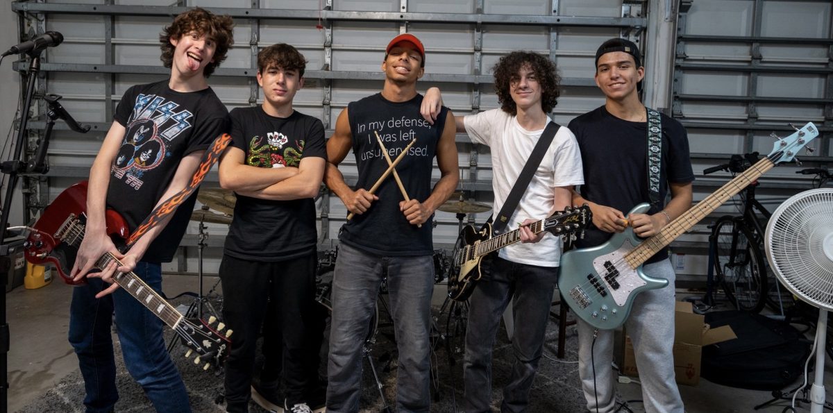 Rock band HB Boulevard stands with their instruments in hand after a practice in their lead singer's garage. The band consists of vocalist Lawson Jay, lead guitarist Jose Nunez, rhythm guitarist Logan Siskin, drummer Josiah Jimenez, and bassist Anthony Pelito, who are all seniors at MSD.