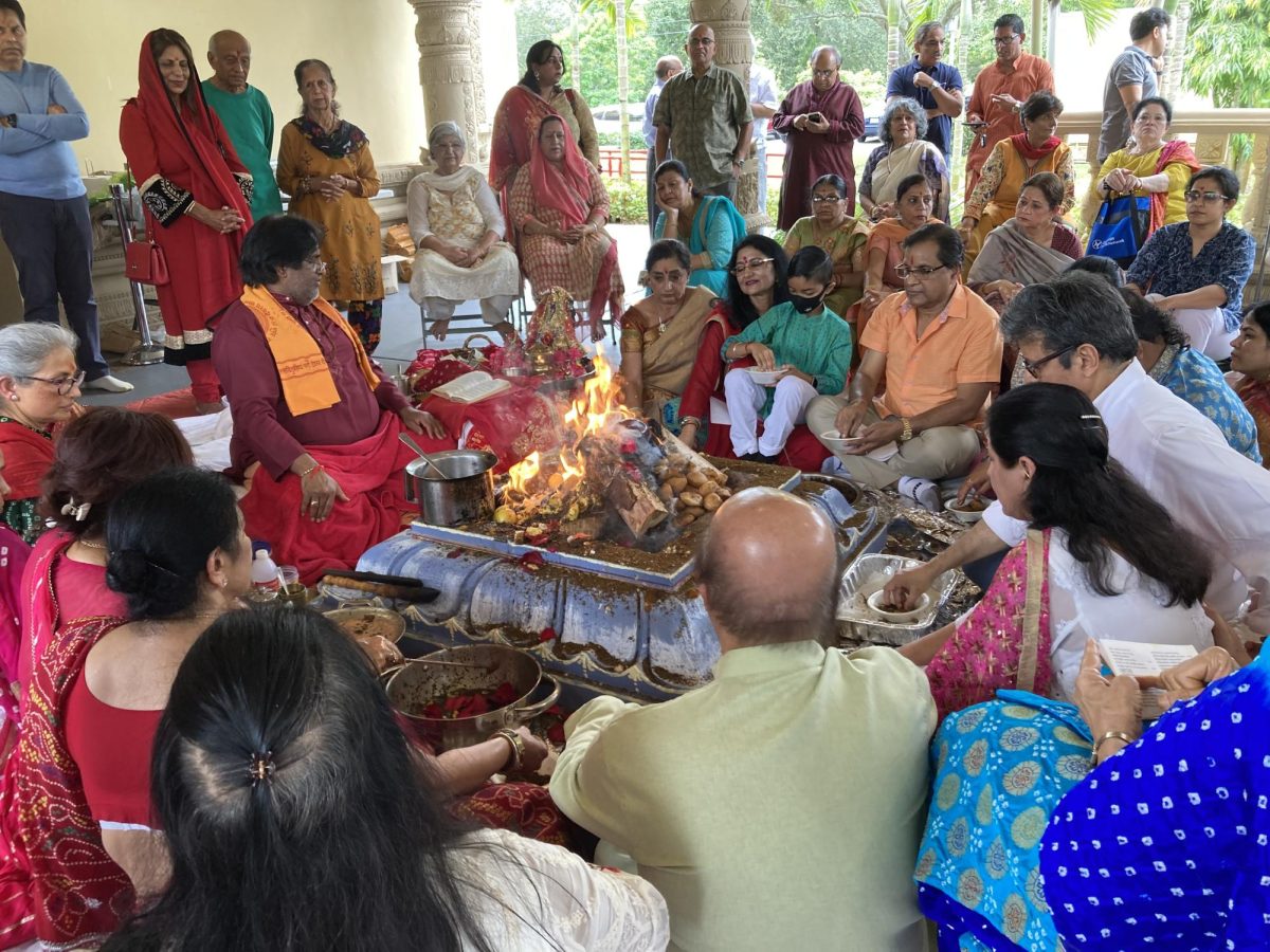 GURU GATHERING. Sophomore Ria Sethi gathers with family and friends to listen to prayers for Diwali.  They listen to a Guru who recounts stories of the significance of the holiday. At the conclusion of the event, the participants will celebrate with a feast to honor the holiday. 