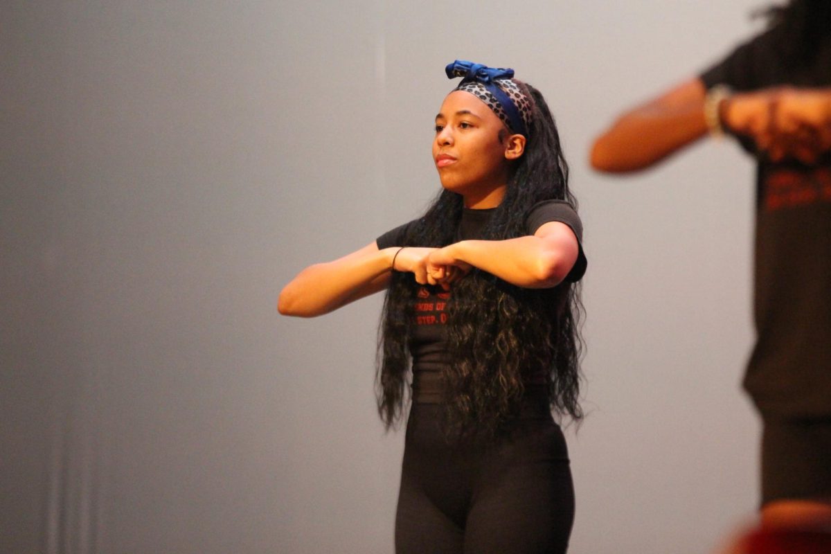 Senior Dana Wilson performs with the MSD's Legends of Destiny Step Team on Jan. 25 for the Mr. Douglas Pageant Show. LOD Step Team, along with LED Dance Club and a few students performing a lip-sync battle, were there as a short break for the audience at Mr. Douglas.