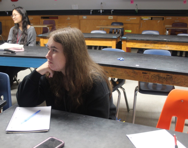 While listening to the AP Biology review after school on Monday, April 21, junior Mylie Mayberry takes notes. As testing season approaches, teachers, like AP Biology teacher Itza Sierra, have been holding after-school review sessions that students can attend to refresh their knowledge. "I feel prepared for the exam because I have been attending every review session, I have been studying on my own and I've been doing good on the mock exams," Mayberry said.